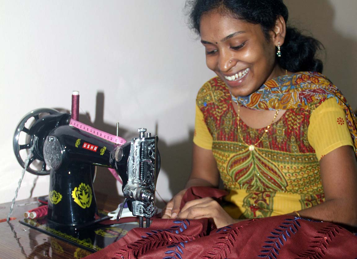 A woman sitting in front of a sewing machine.
