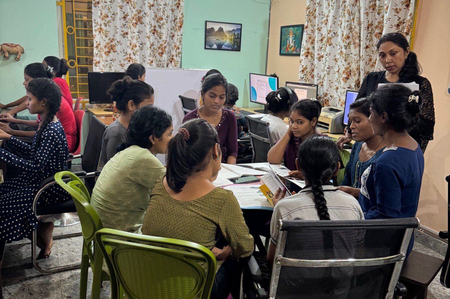Group of students engaged in a discussion around a table.