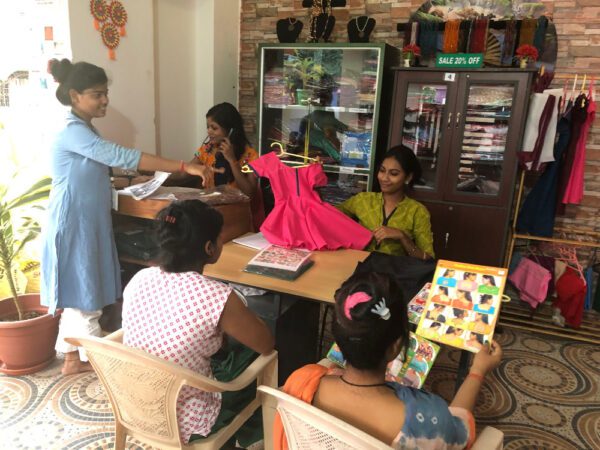 Children engaged in art and craft activities at a classroom table.